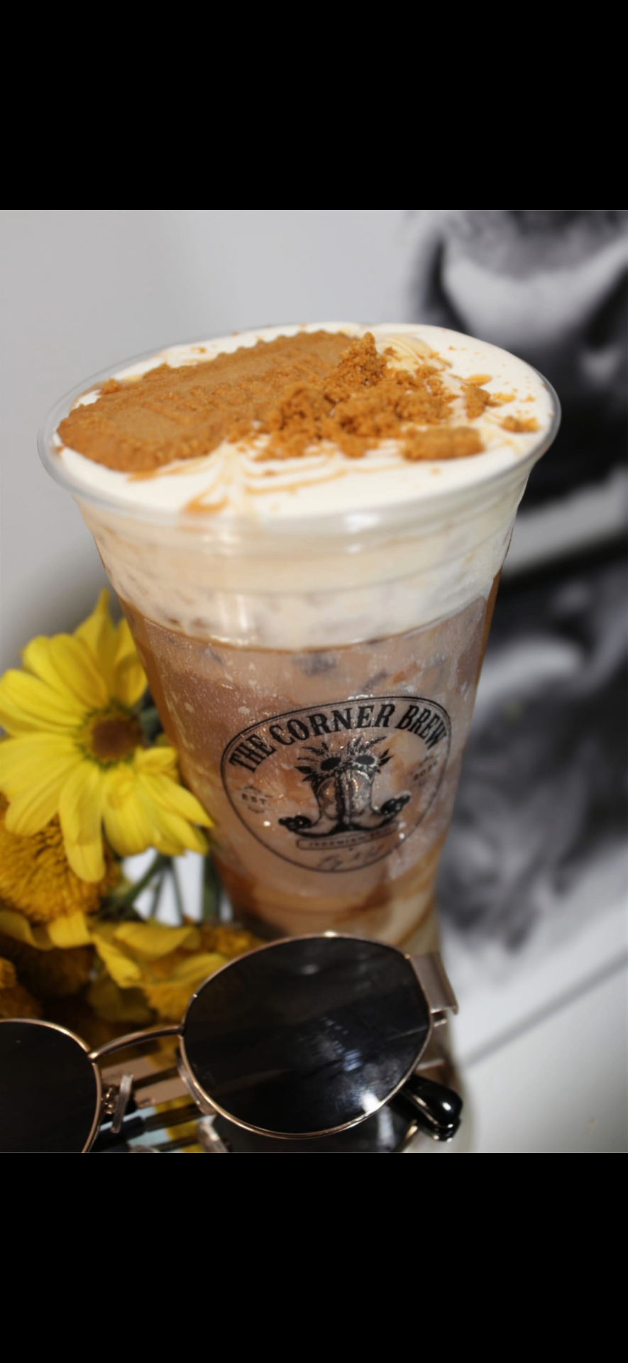 Iced Biscoff latte topped with whipped cream and crushed Biscoff cookies